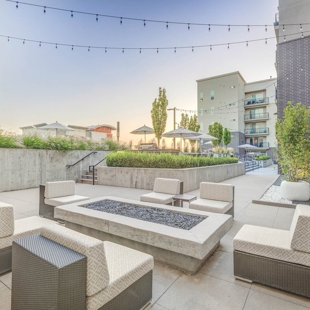 Encore Apartments - Outdoor Lounge Area with Fireplace